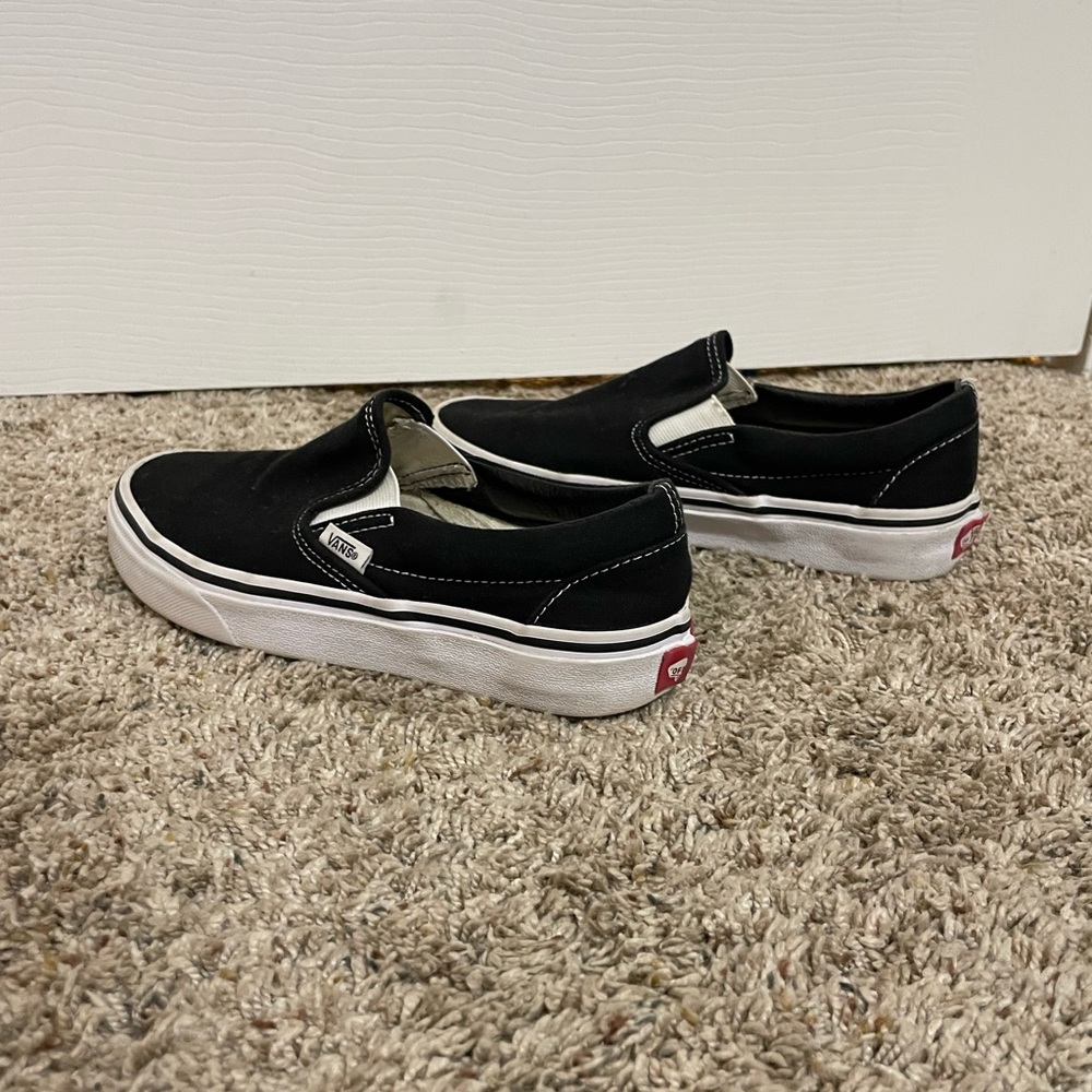 Women’s size 5. Five black slip on vans